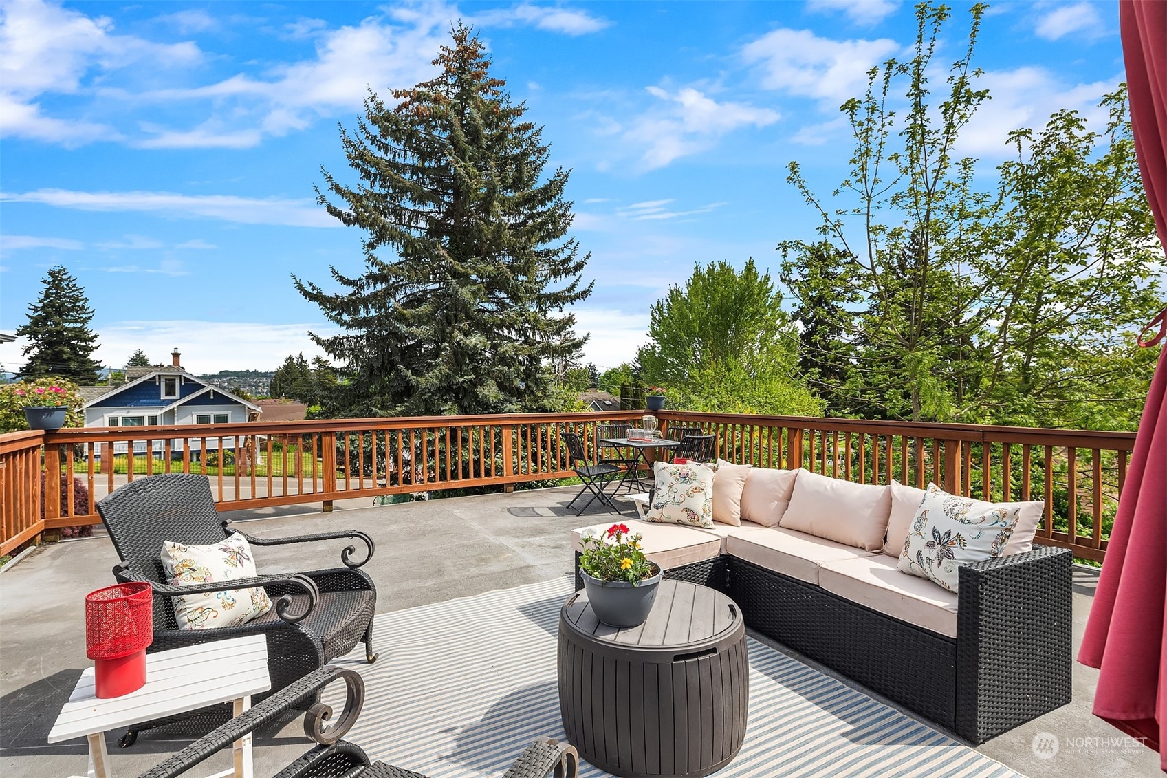 201 Thomas Avenue Southwest Renton, WA 98057 - Photo 1 of 38 a balcony with wooden floor and outdoor seating