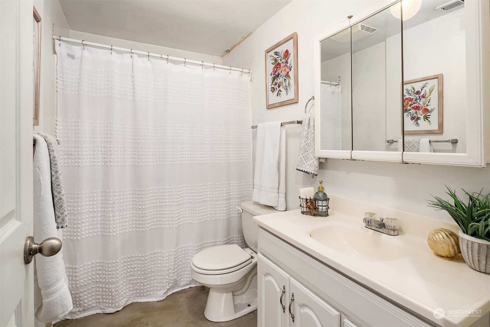 201 Thomas Avenue Southwest Renton, WA 98057 - Photo 23 of 38 a bathroom with a sink a toilet and shower curtain