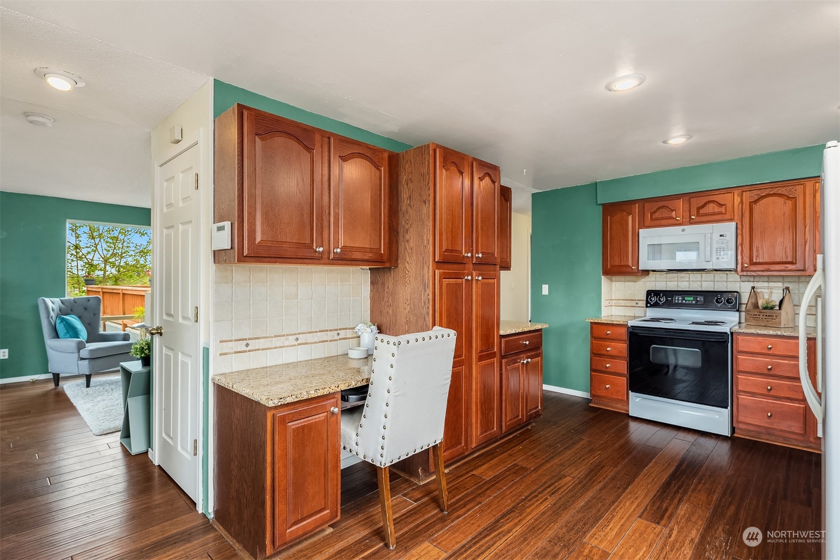 201 Thomas Avenue Southwest Renton, WA 98057 - Photo 8 of 38 a kitchen with stainless steel appliances a stove top oven a sink dishwasher and a refrigerator with wooden floor