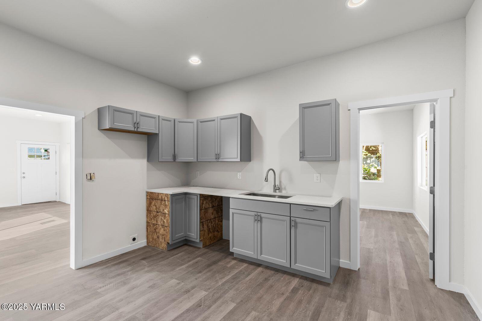 711 North 3rd Street Yakima, WA 98901 - Photo 13 of 21 a kitchen with a sink a stove cabinets and wooden floor