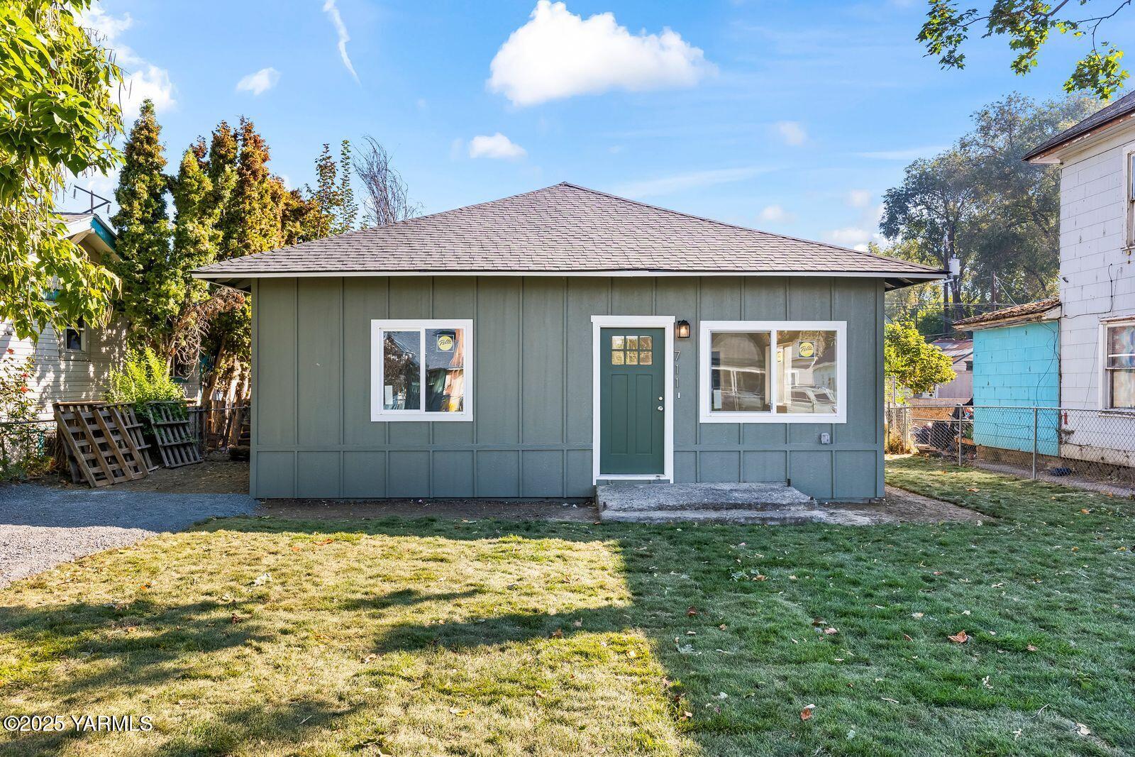 711 North 3rd Street Yakima, WA 98901 - Photo 14 of 21 a front view of a house with a yard