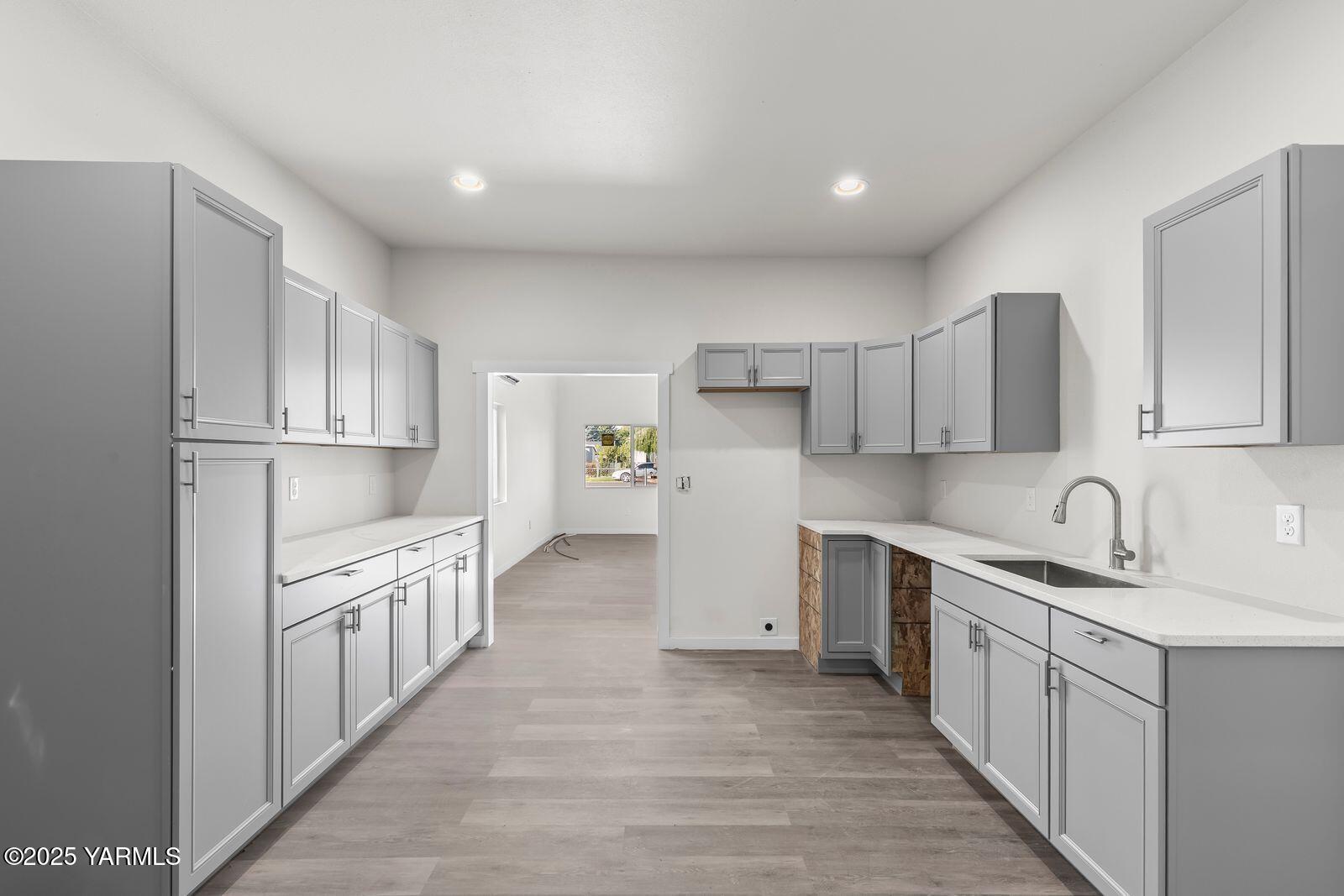 711 North 3rd Street Yakima, WA 98901 - Photo 20 of 21 a kitchen with white cabinets sink and stove