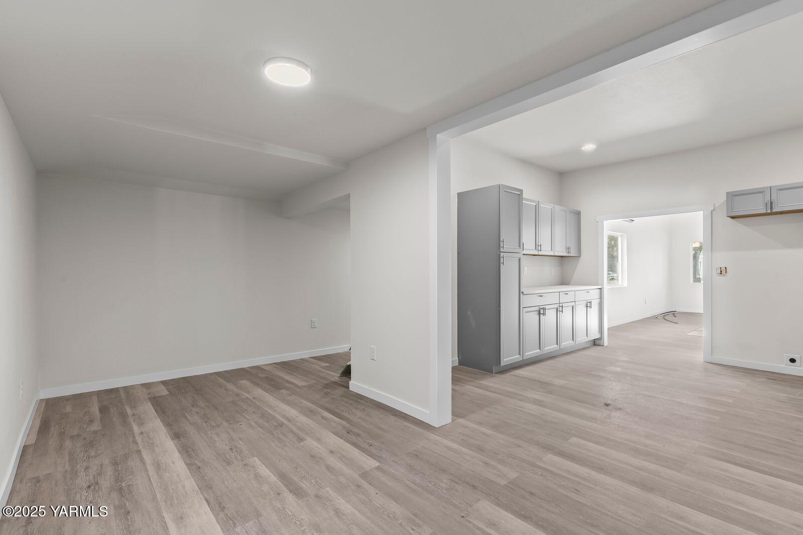 711 North 3rd Street Yakima, WA 98901 - Photo 4 of 21 a view of kitchen with refrigerator cabinets and wooden floor