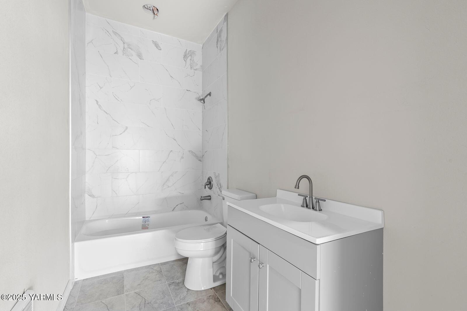 711 North 3rd Street Yakima, WA 98901 - Photo 7 of 21 a bathroom with a sink a toilet and shower