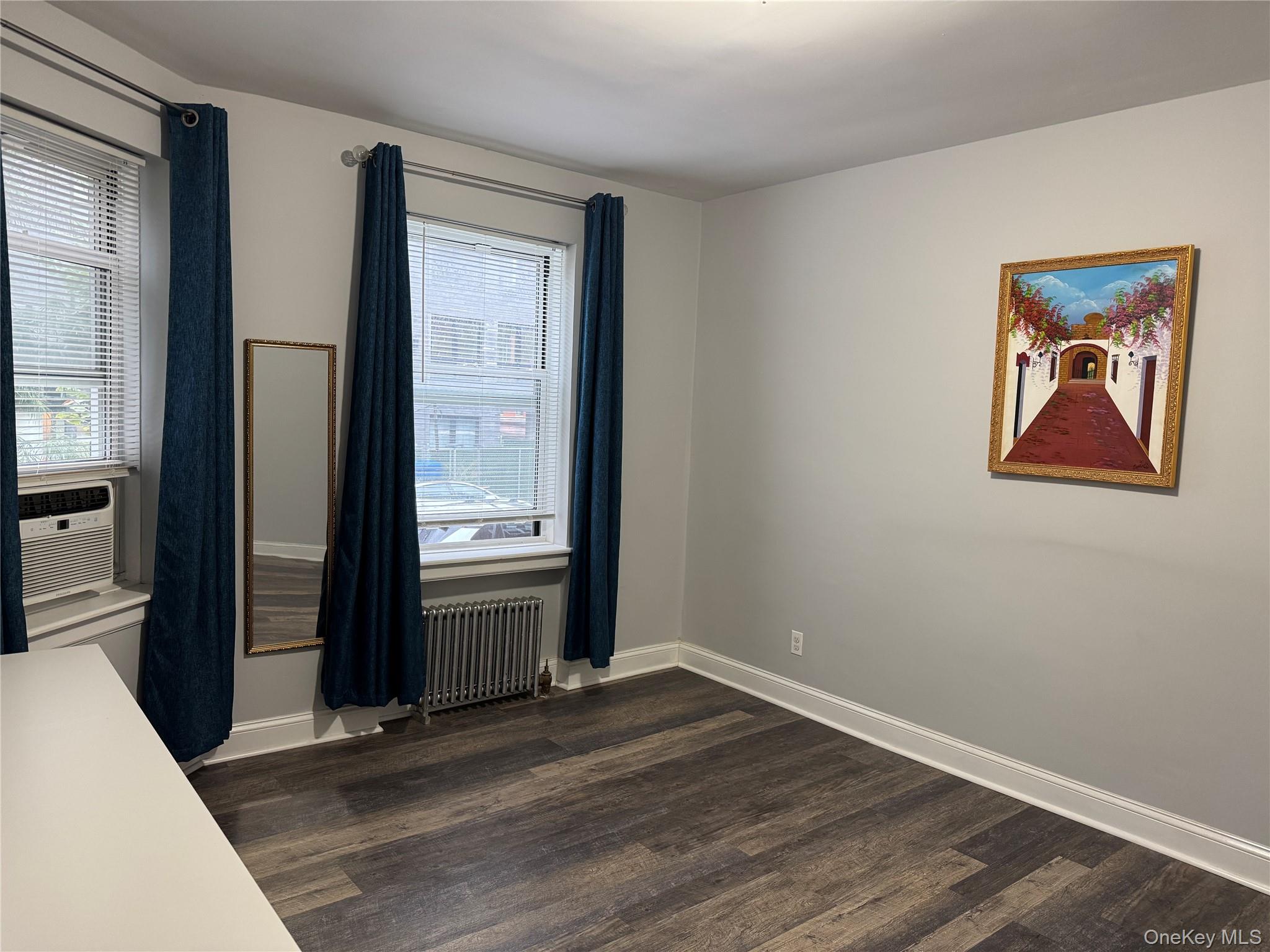 141-12 78th Avenue, Unit 1G Queens, NY 11367 - Photo 11 of 16 a view of a hallway with wooden floor and windows