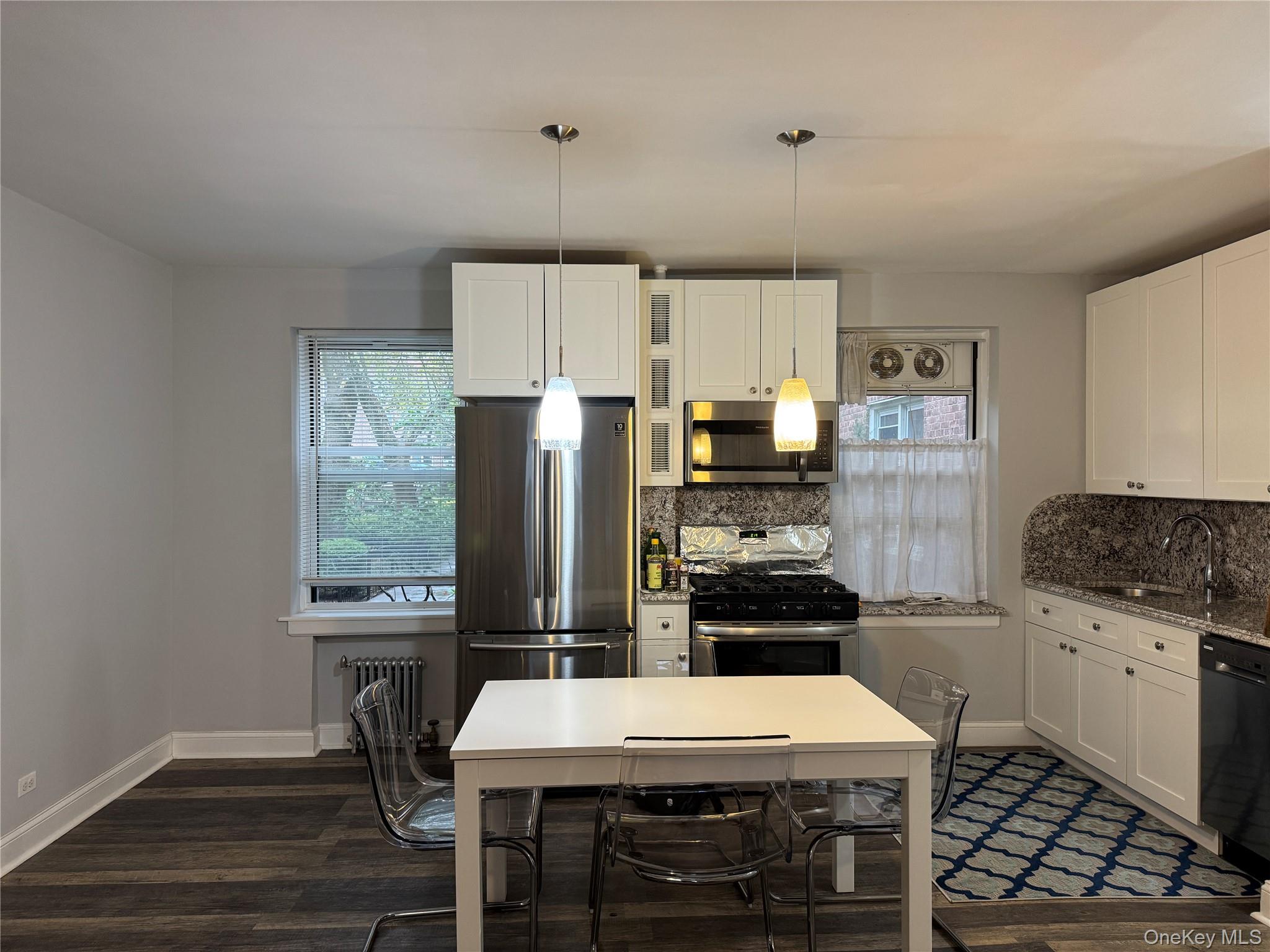 141-12 78th Avenue, Unit 1G Queens, NY 11367 - Photo 4 of 16 a kitchen with a stove a refrigerator and a stove