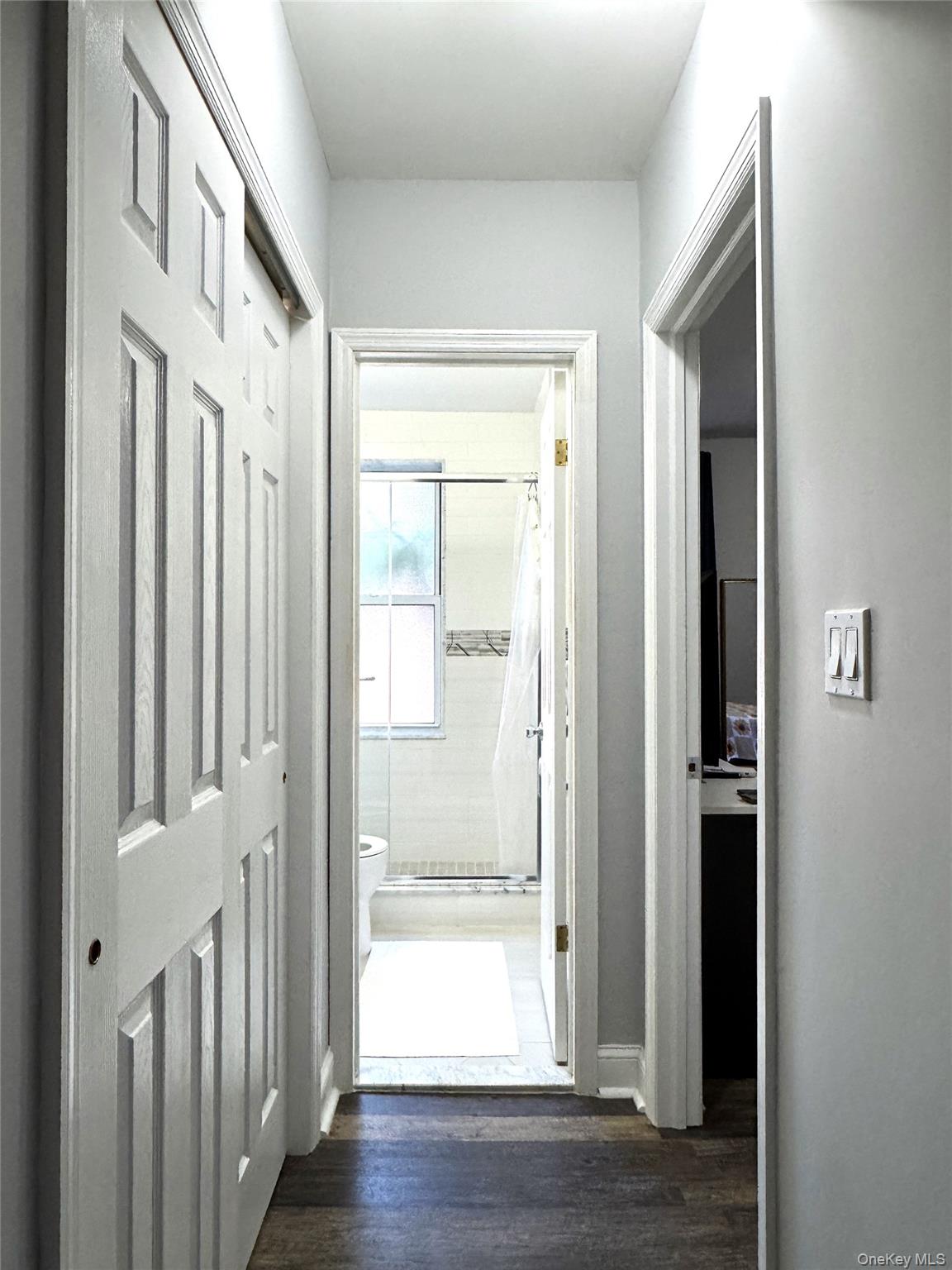 141-12 78th Avenue, Unit 1G Queens, NY 11367 - Photo 7 of 16 a view of a hallway with wooden floor and closet area