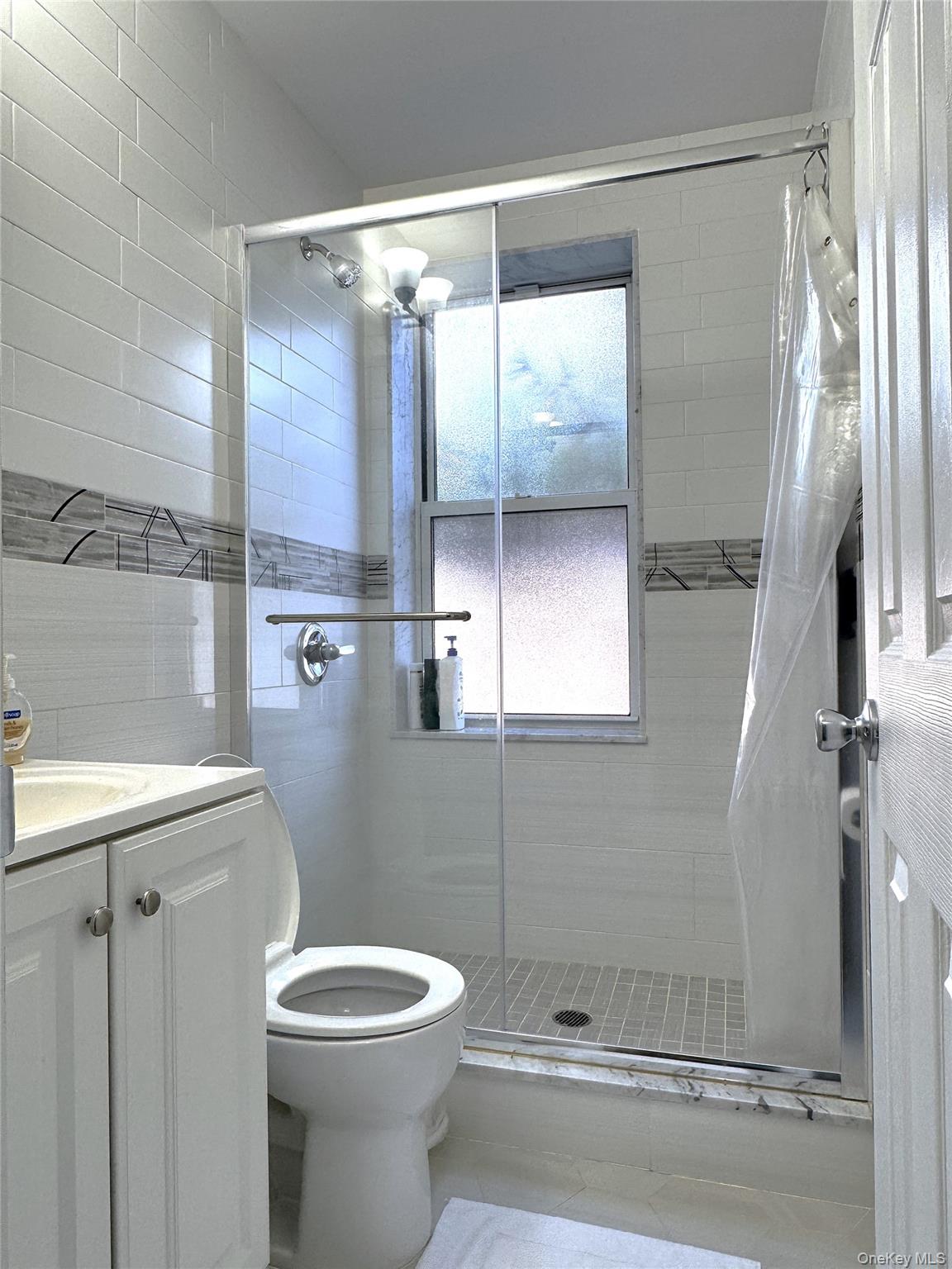 141-12 78th Avenue, Unit 1G Queens, NY 11367 - Photo 8 of 16 a bathroom with a toilet and a shower
