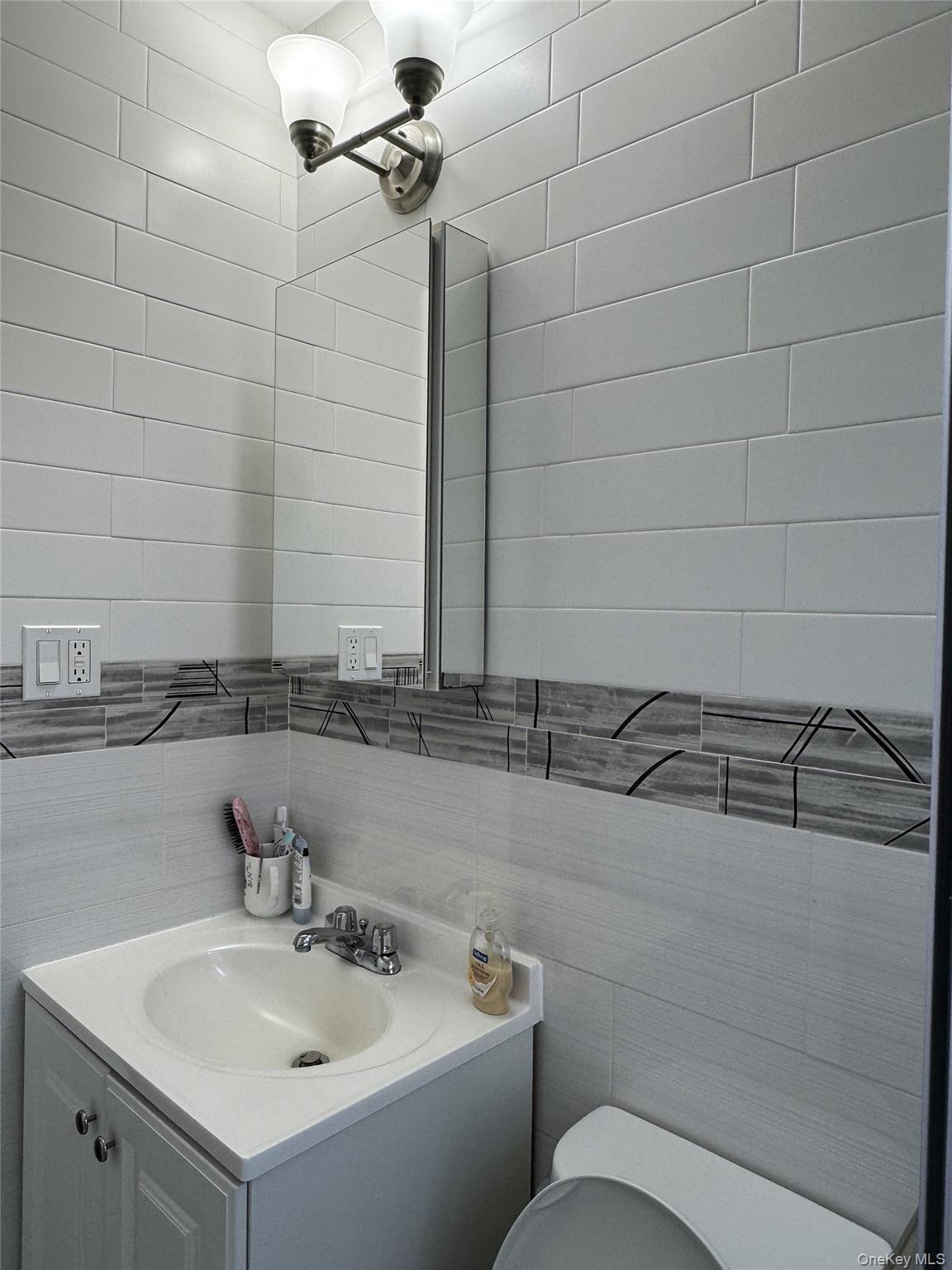 141-12 78th Avenue, Unit 1G Queens, NY 11367 - Photo 9 of 16 a bathroom with a sink and a toilet