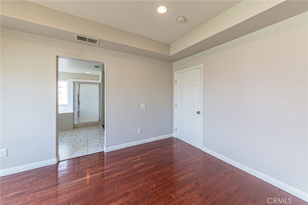 17645 Loganberry Road Carson, CA 90746 - Photo 20 of 56 a view of an empty room with wooden floor