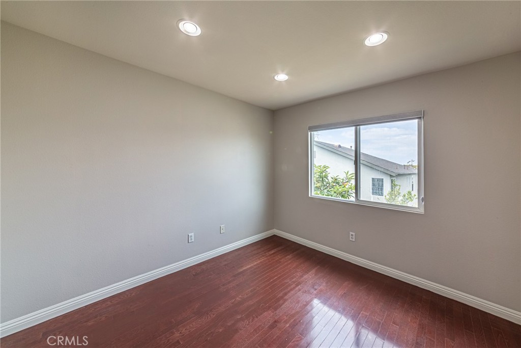 17645 Loganberry Road Carson, CA 90746 - Photo 25 of 56 an empty room with wooden floor and windows
