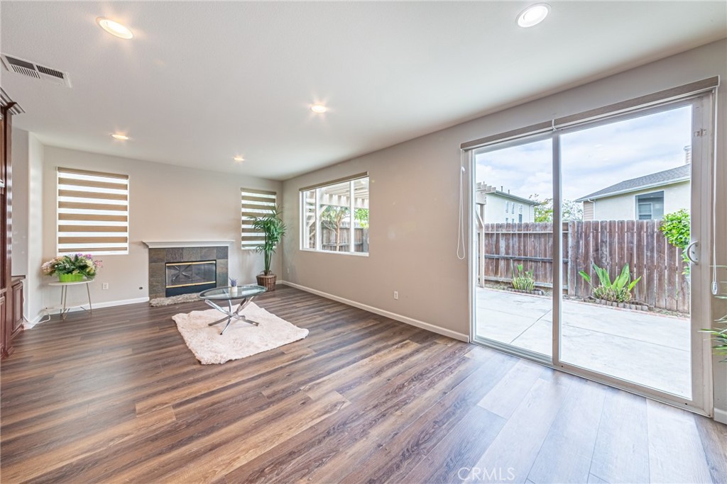 17645 Loganberry Road Carson, CA 90746 - Photo 4 of 56 a view of a livingroom with wooden floor and a fireplace