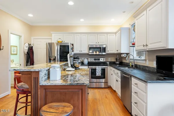 a view of a dining room with furniture a chandelier and wooden floor
