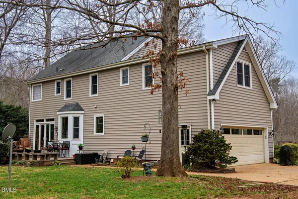 a kitchen with stainless steel appliances granite countertop a refrigerator a stove a sink cabinets and a dining table