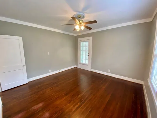 wooden floor in an empty room with a window