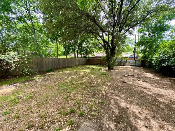 a view of a yard with large trees