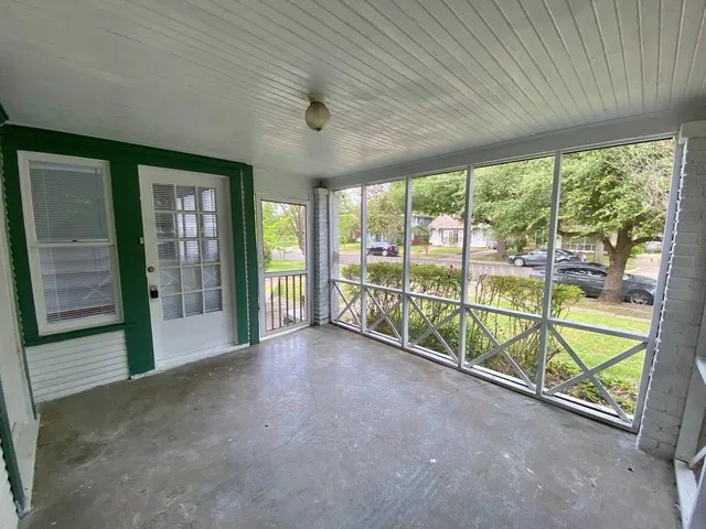 a view of an empty room with windows
