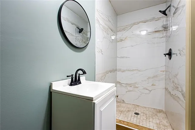 a bathroom with a sink a toilet and a shower