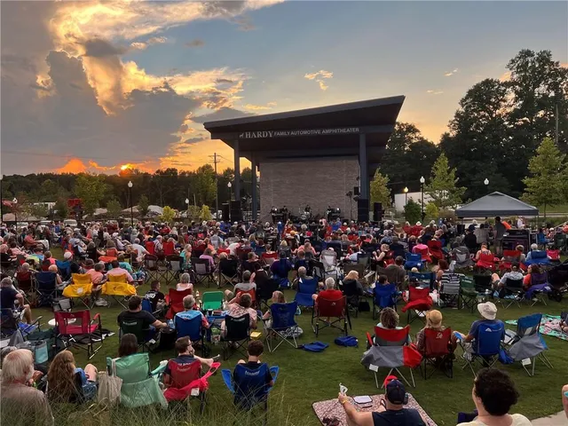a group of people standing around a fruit stand