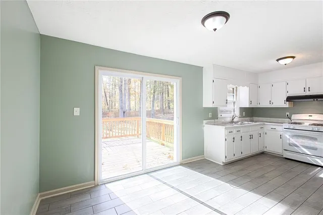 a kitchen with a stove a sink and a refrigerator