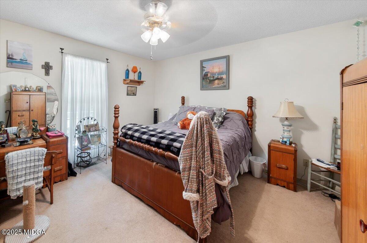 856 Lite-N-Tie Road Macon, GA 31211 - Photo 17 of 45 a bed room with a bed and a couch