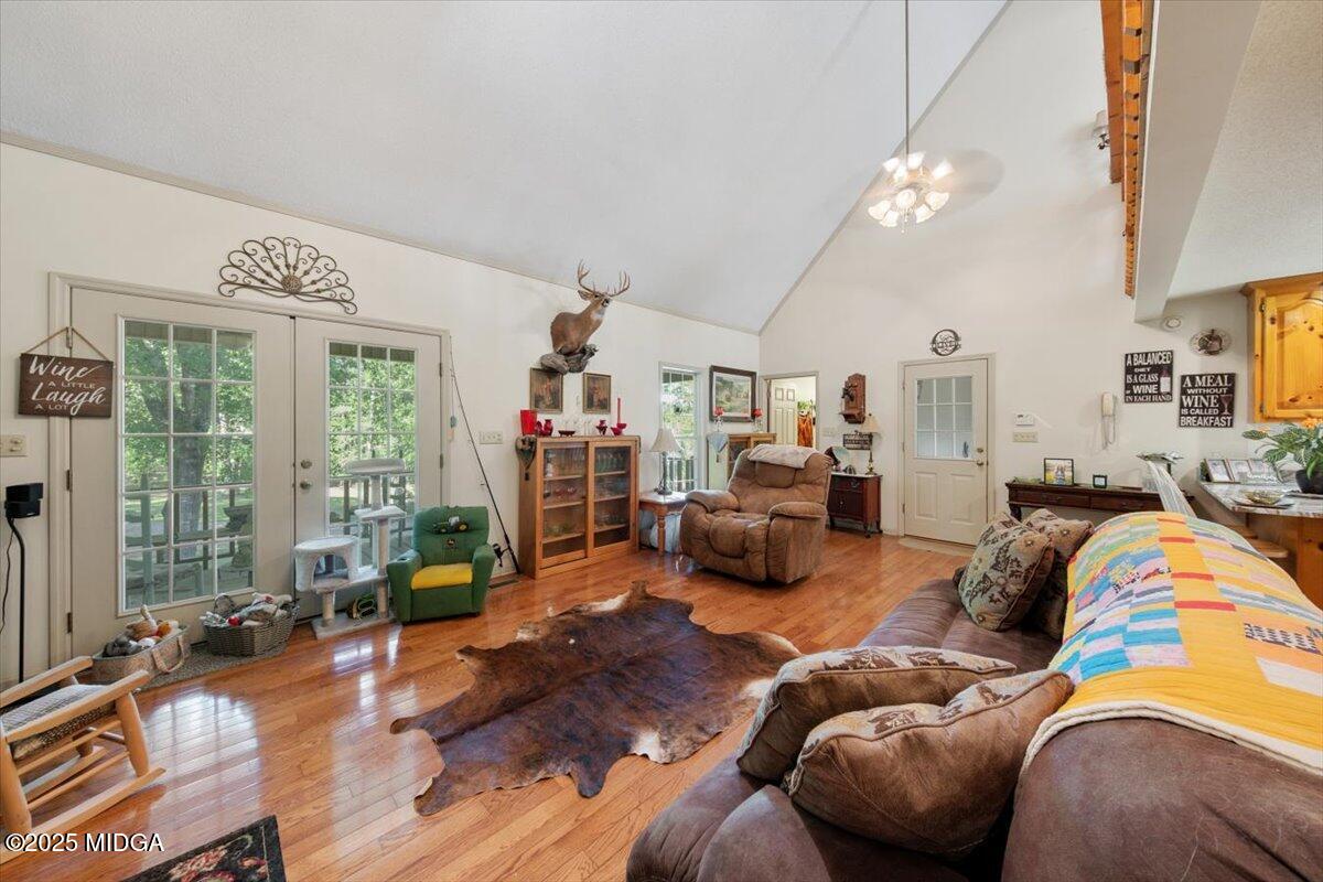 856 Lite-N-Tie Road Macon, GA 31211 - Photo 6 of 45 a living room with furniture a chandelier and a large window