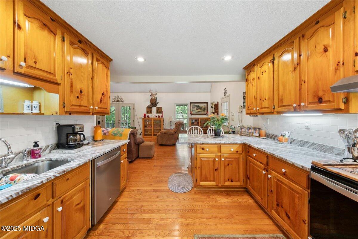 856 Lite-N-Tie Road Macon, GA 31211 - Photo 8 of 45 a large kitchen with stainless steel appliances granite countertop a sink and cabinets