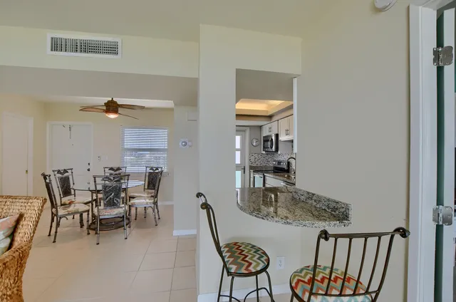 a view of a dining room with furniture and a window
