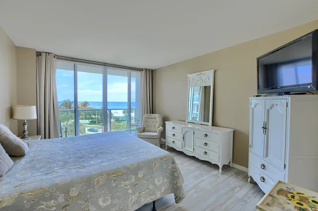 a bedroom with a bed and a night stand