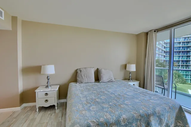 a bathroom with a granite countertop toilet and a shower