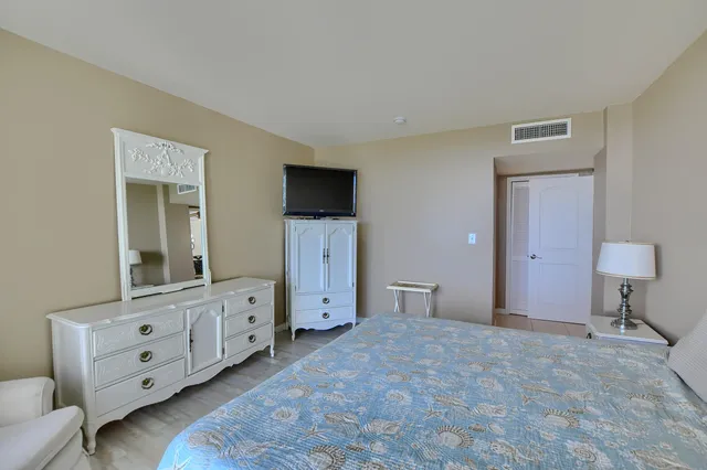 a bathroom with a granite countertop sink a mirror and shower