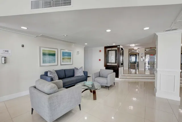 a view of staircase with furniture and floor to ceiling window