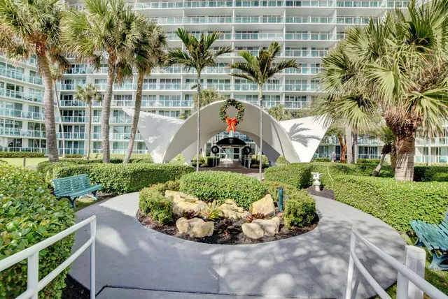 a front view of a house with a garden and plants