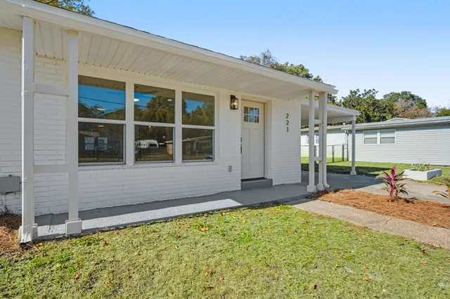 a view of a kitchen with a sink and a refrigerator
