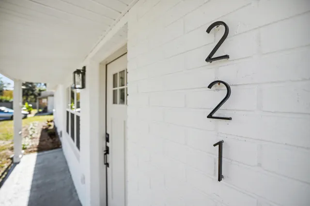 a view of a kitchen with a sink and wooden floor
