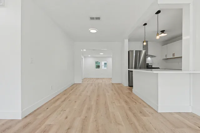 a kitchen with a sink cabinets and a window