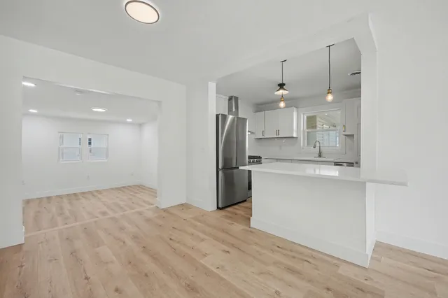 a bathroom with a shower sink and mirror