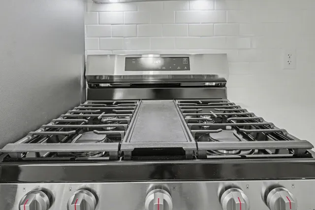a view of a big room with wooden floor and windows