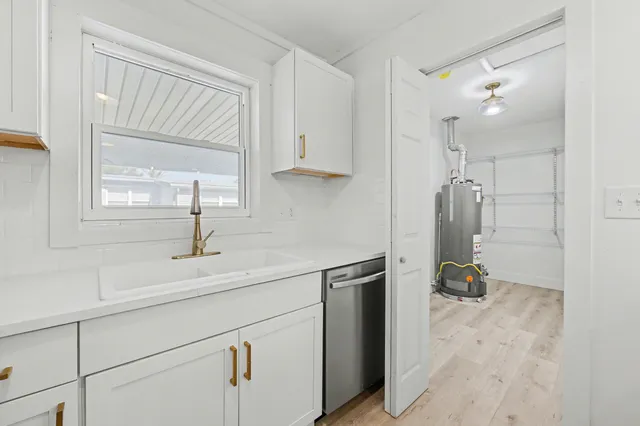 a view of a room with wooden floor and white walls