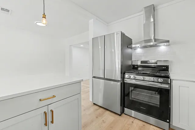 a view of a bedroom with wooden floor and iron stairs