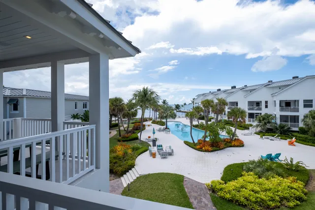 a living room with furniture a rug and a floor to ceiling window