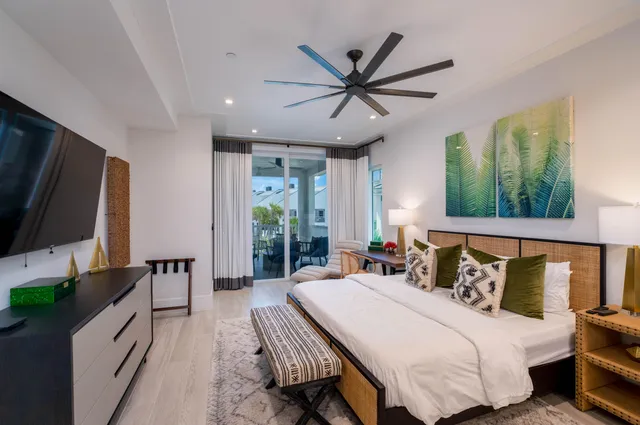 a view of a patio with couches table and chairs and potted plants