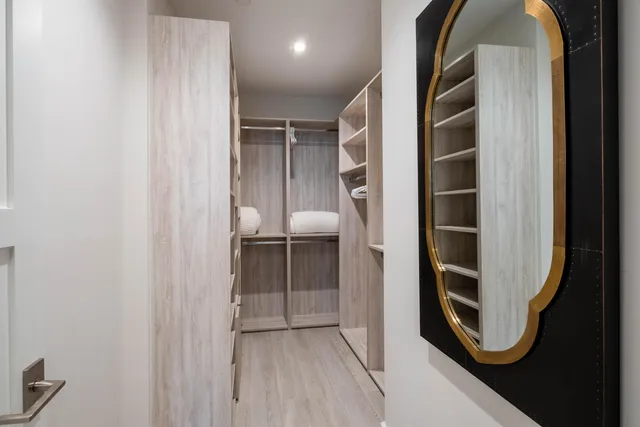 a bathroom with a double vanity sink a mirror and a bathtub