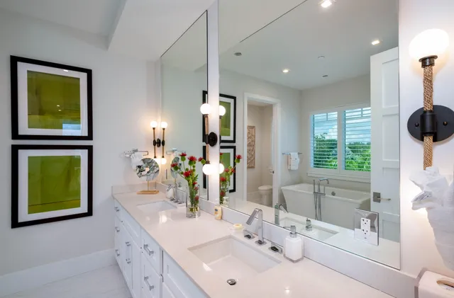 a spacious bathroom with a double vanity sink shower and mirror