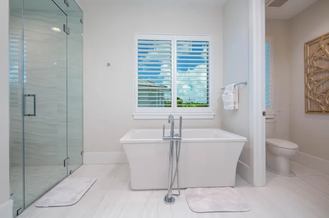 a bathroom with a toilet sink vanity and mirror