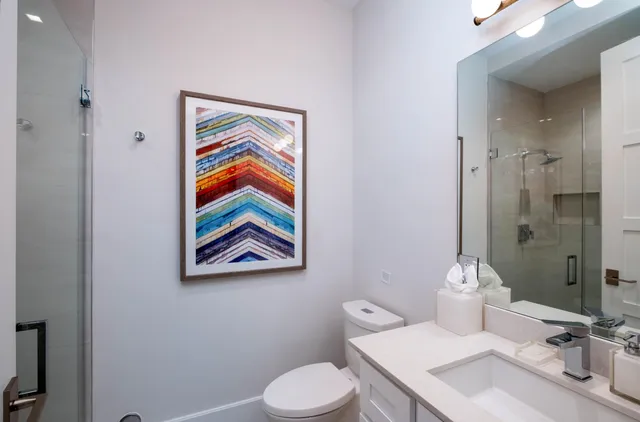 a bathroom with a toilet and a shower