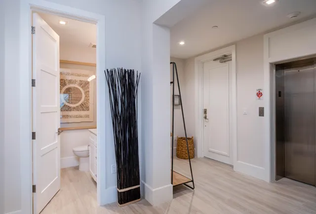 a bathroom with a toilet sink vanity and mirror
