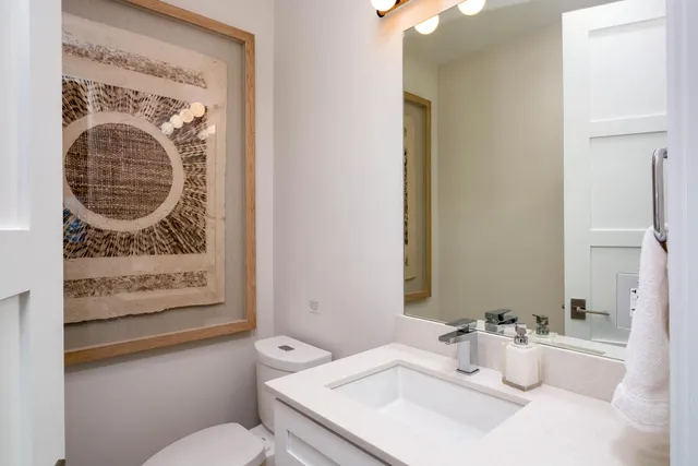 a bedroom with a bed and a painting on the wall