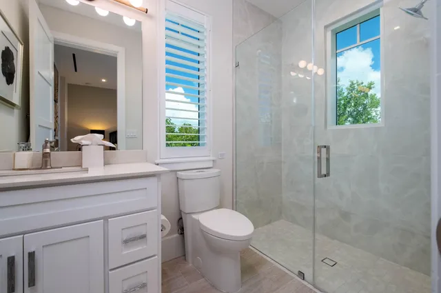 a bedroom with a bed and a flat tv screen on the dresser