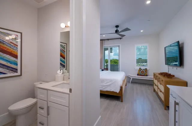 a bedroom with a bed a dresser and chair